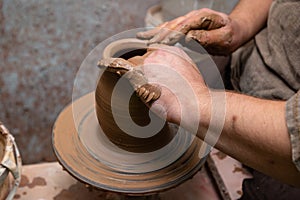Creating a pot of clay close-up. Hands making products from clay. Potter at work