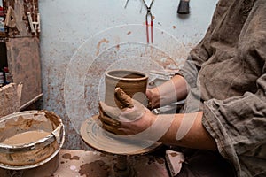 Creating a pot of clay close-up. Hands making products from clay. Potter at work