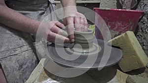 Creating vase of clay close-up. The sculptor in workshop makes jug out of clay closeup.