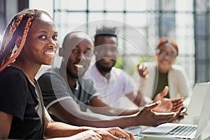 Creation of a new application in a team. young programmers sit at the table