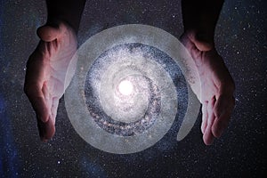 Creationism concept. Hands of God are creating Galaxy in universe. photo