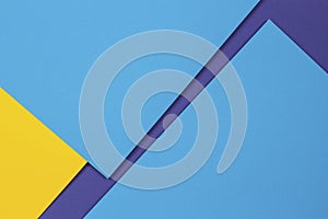 Creative abstract blue and yellow color geometric paper compositon background, top view