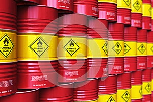 Group of rows of red stacked oil drums in storage warehouse