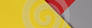 Creative abstract yellow, red and gray color geometric paper compositon background, top view