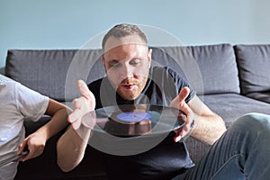 Creative adult man with vinyl records, hobbies and leisure