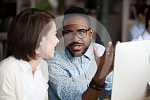 Creative african american and caucasian workers discussing work chatting photo