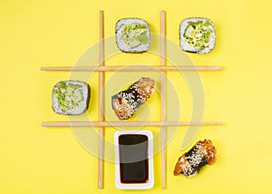 Creative Arrangement of Sushi and Sashimi on Yellow Background for Japanese Cuisine Concept