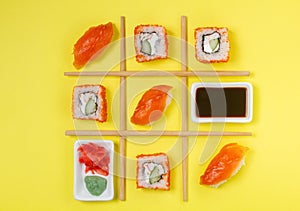 Creative Arrangement of Sushi and Sashimi on Yellow Background for Japanese Cuisine Concept