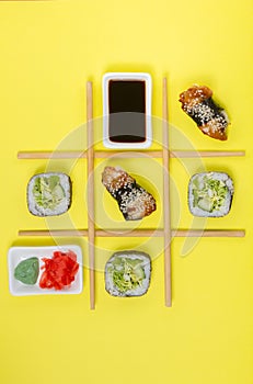 Creative Arrangement of Sushi and Sashimi on Yellow Background for Japanese Cuisine Concept