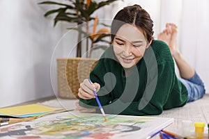 Creative of art concept, Young asian woman lying on the floor and work to painting art masterpiece