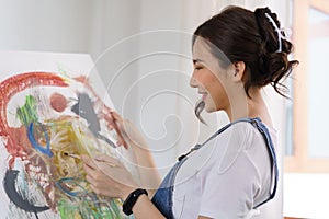 Creative of art concept, Young asian woman sitting in studio to create drawing the artwork