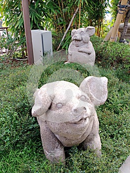 Creative art of stone pig statues. In Chinese culture, pigs are a symbol of fertility and virility, good luck and prosperity