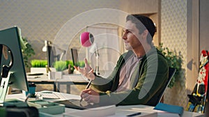 Creative artist staring computer screen modern office. Smiling man having idea