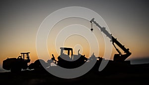 Abstract Industrial background with construction crane silhouette over amazing sunset sky. Mobile crane against the evening sky.
