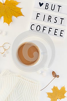 Creative autumn flat lay overhead top view coffee cup vintage lightbox But coffee first text sweater white background copy space