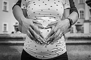 Creative baby bump photo shoot with pregnant mother and father