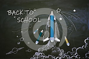 Creative back to school sketch with pencils and rocket on chalkboard wall wallpaper. Education concept
