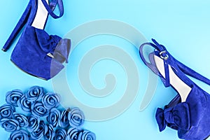 Creative backdrop with high heels shoes and accessories on blue background