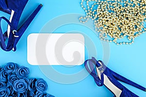 Creative backdrop with high heels shoes and accessories on blue background