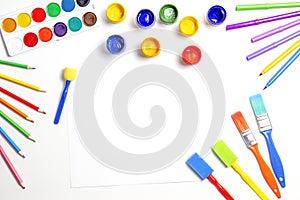 Creative background with art supplies on white background