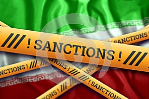 Creative background, inscription on the flag of Iran, sanctions, yellow fencing tape. The concept of sanctions, policies,