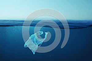 Creative background, plastic bag floating in the ocean, bag in the water. Concept of environmental pollution, non-decomposable