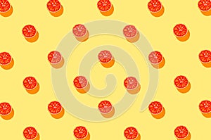 Creative banner pattern made with half of blood orange on bright yellow background. Summer fruit and vitamin concept. Minimal