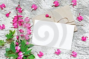 Creative branding mock up to display your artworks. blank greeting card with pink flowers with heart shaped buds