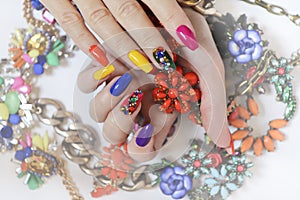 Creative bright saturated manicure on long nails with rhinestones.