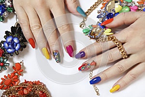 Creative bright saturated manicure on long nails with rhinestones.