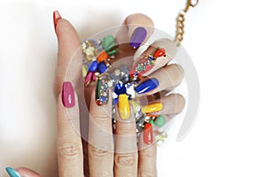 Creative bright saturated manicure on long nails with rhinestones.