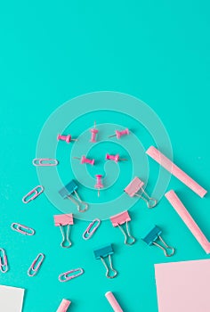 Creative business concept made of  colorful paper clips, chalks, pencil, papers. Blue background. Flat lay.
