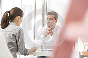 Creative business people discussing at desk in office