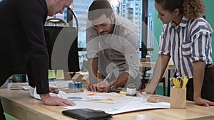 Creative business people group having conversation at office desk in workplace.