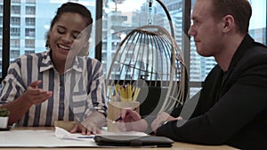 Creative business people group having conversation at office desk in workplace.