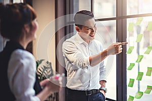 Creative Business People Writing on Sticky Notes to Analyzing and Brainstorm in Coworking Space