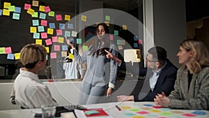 Creative Business Team Brainstorming Ideas Working Together Near Glass Wall With Sticky Notes. Colleagues approve