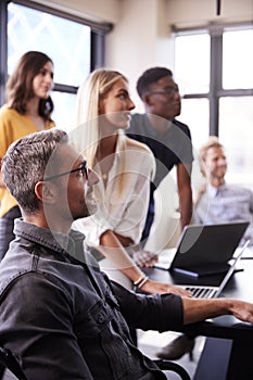 Creative business team listening at a brainstorm meeting, close up, vertical