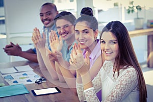 Creative business team at meeting applauding