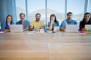 Creative business team sitting in a row and working together in office