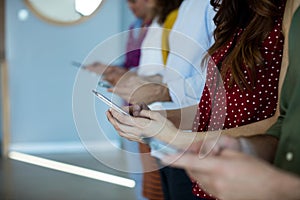 Creative business team using mobile phone in office