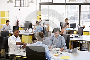 Creative business team working in a busy open plan office