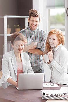 Creative business workers using laptop