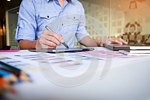 Creative businessman or designer writing on graphic tablet while