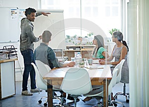 Creative businessman showing idea on a whiteboard during a business collaboration or teamwork meeting, talking working