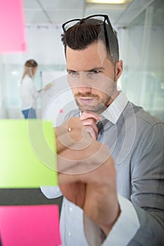 creative businessman writing notes on paper in office