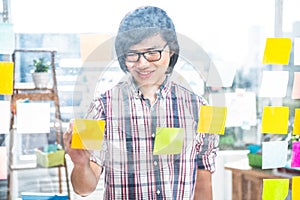 Creative businessman writing on sticky notes