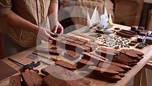 Creative carpenter checking wood material for further processing