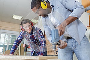 creative carpenter works with colleague