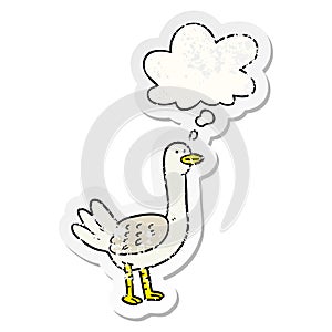 A creative cartoon bird and thought bubble as a distressed worn sticker